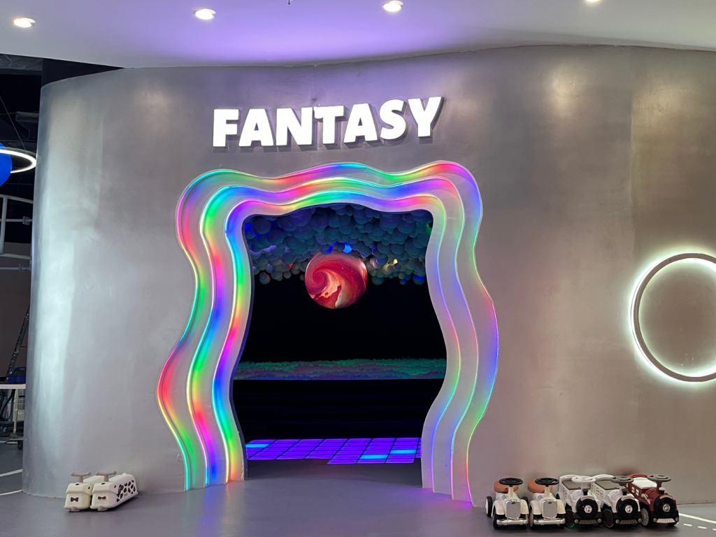 A wide view of UFOREA's Dazzling Light Fantasy Zone with mirror walls and pastel-neon floor