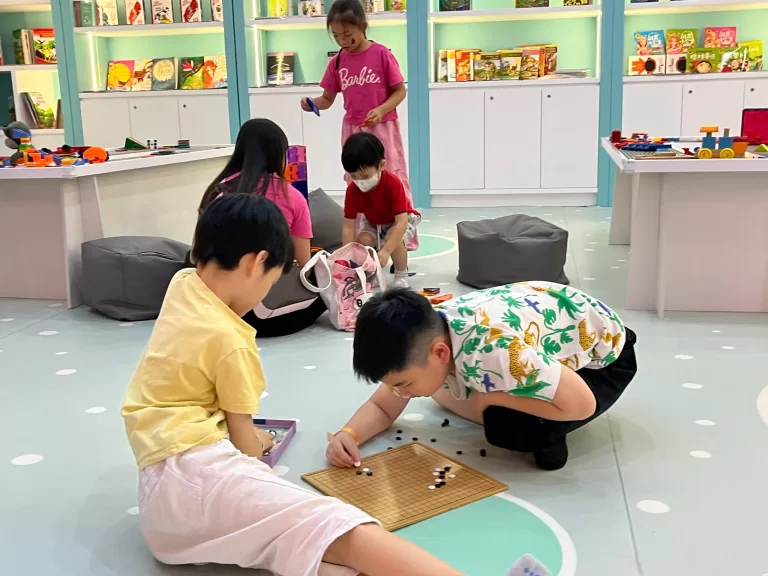 Kids playing together at UFOREA's Cozy Nook reading area